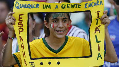 Brazil Fan holds a paper TV