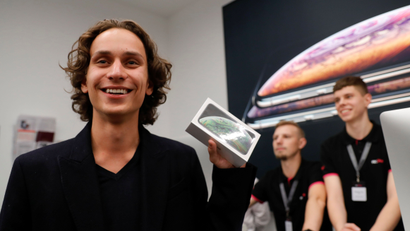 A customer reacts during the launch of the new iPhone XS and XS Max smartphones sales at "re:Store" Apple reseller shop in Moscow, Russia September 28, 2018. REUTERS/Tatyana Makeyeva - RC150E6310F0