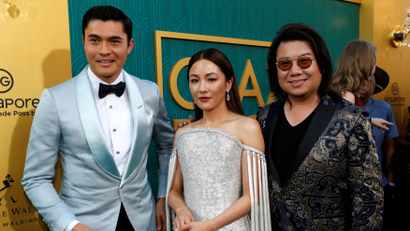 Author Kevin Kwan (R) and cast members Henry Golding and Constance Wu pose at the premiere for "Crazy Rich Asians" in Los Angeles, California, U.S., August 7, 2018.
