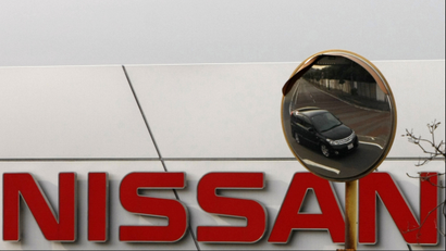 A Nissan car is reflected in a mirror outside a Nissan Motor Co factory in Yokosuka, south of Tokyo, February 9, 2009. Nissan Motor Co, Japan's No. 3 carmaker, posted a big quarterly loss on Monday and warned it would lose money this year, making its first fall into the red since Chief Executive Carlos Ghosn took the reins in 1999. REUTERS/Toru Hanai