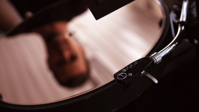 A person playing a vinyl record.