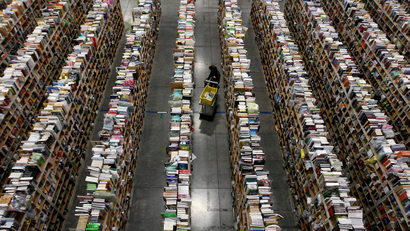 A worker gathers items for delivery from the warehouse floor at Amazon's distribution center in Phoenix, Arizona November 22, 2013. The web-based retailer is preparing for Cyber Monday, which is traditionally the busiest day of the year for online purchases, and falls on December 2 in 2013. REUTERS/Ralph D. Freso (UNITED STATES - Tags: BUSINESS TPX IMAGES OF THE DAY EMPLOYMENT) - GM1E9BN0U6B01