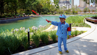 A boy dressed in a replica uniform of the Chinese Communist Party's Red Army.