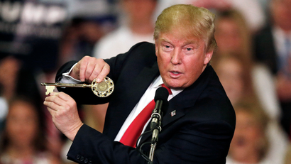 Republican presidential candidate Donald Trump holds up a key to the city he brought onto stage with him as he speaks at a campaign rally Monday, March 7, 2016, in Madison, Miss.
