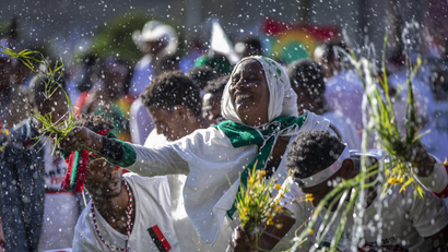 Ethiopians throw grass into a pool of water, as a symbol of riches after the rainy season and to thank the land and water for everything they have provided, as they celebrate the annual Irrecha thanksgiving festival in the capital Addis Ababa, Ethiopia Saturday, Oct. 5, 2019. The annual Irrecha festival of Ethiopia's largest ethnic group, the Oromo, attracted millions from across Ethiopia and was held in the capital for the first time after 150 years on Saturday.
