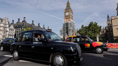 Black cabs pass Parliament in London