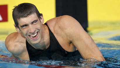 US swimmer Michael Phelps smiles as he leaves the pool after setting a new world record in the men's 100m butterfly event at the USA Swimming National Championships in Indianapolis, Indiana, July 9, 2009