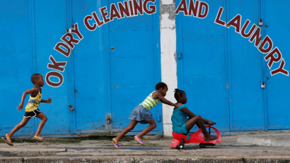 Children play in front of a closed shop in Monrovia, Liberia, July 5, 2016. Picture taken on July 5, 2016.