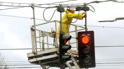Electrician-fixes-traffic-light