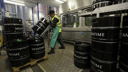 An employee moves beer barrels at the Meantime brewery in east London.