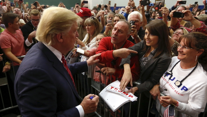 U.S. Republican presidential candidate Donald Trump speaks with supporters as he prepares to leave a campaign event in Anderson, South Carolina October 19, 2015.