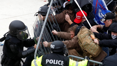 Pro-Trump protesters tear down a barricade as they clash with Capitol police during a rally to contest the certification of the 2020 U.S. presidential election results by the U.S. Congress, at the U.S. Capitol Building in Washington, U.S, January 6, 2021.