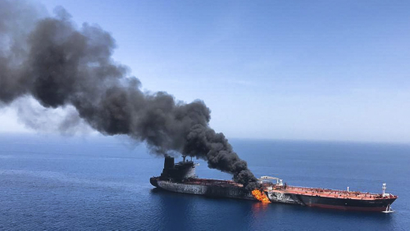 A flaming oil tanker in the sea of Oman.
