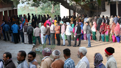 Voters line up to cast their votes outside a polling station during the state assembly election in the northern state of Punjab, in the village of Nada
