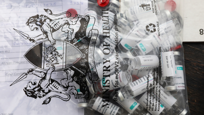 Empty vials of the Oxford-AstraZeneca vaccine inside a plastic bag with Kenya's coat of arms printed on it.