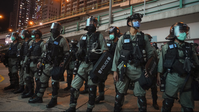 Riot police stand guard after pushing back protesters demonstrating against the new security law during the anniversary of the Hong Kong handover from Britain