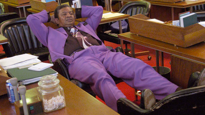 man sitting with feet on desk