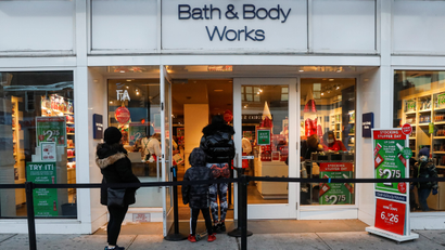 Shoppers wait outside in a queue a Bath and Body Works retail store in New York City during the holiday shopping season.