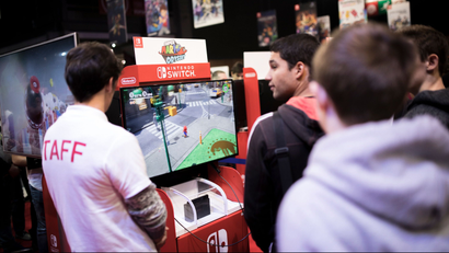 Visitors play Mario Odyssey video game at the Nintendo stand at the Paris Games Week in Paris, Friday, Nov. 3, 2017. The Paris Games Week, or more commonly called "PGW" is the French show dedicated to video games and its derivatives.(AP Photo/Kamil Zihnioglu)
