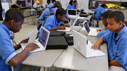 children in classroom with computers