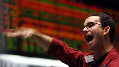 A trader in the S&P 500 pit at the Chicago Board of Trade signal orders shortly before the closing bell.