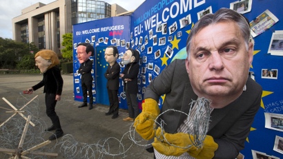 Avaaz's activists wear masks depicting EU leaders during a demonstration in support of migrants in Brussels