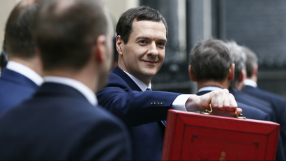Britain's Chancellor of the Exchequer Osborne holds up his budget case for the cameras as he stands outside...