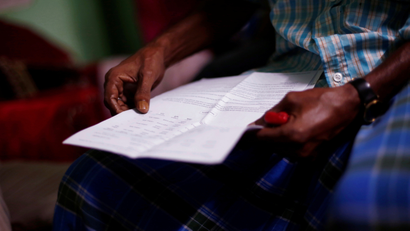 Ayub Salm holds the draft list of the National Register of Citizens (NRC) of his family in Dhubri district.