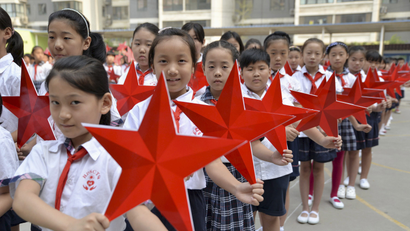 Students pose with red stars during an event to mark the 70th anniversary of the Victory of Chinese People's War of Resistance Against Japanese Aggression and the World Anti-Fascist War, at a primary school in Handan, Hebei province, China, August 31, 2015. China will mark the 70th anniversary of the end of World War Two with a massive military parade this Thursday, with some 12,000 soldiers marching through Beijing's central Tiananmen Square. REUTERS/China Daily CHINA OUT. NO COMMERCIAL OR EDITORIAL SALES IN CHINA. - RTX1QCK3