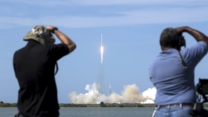 Photographers take pictures of the unmanned SpaceX Falcon 9 rocket with Dragon lifts off from launch pad 40 at the Cape Canaveral Air Force Station in Cape Canaveral, Florida April 14, 2015.