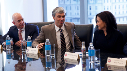 Larry Page, CEO and Co-founder of Alphabet, speaks while Sheryl Sandberg, Chief Operating Officer of Facebook, and Amazon CEO Jeff Bezos look on during a meeting with U.S. President-elect Donald Trump and technology leaders at Trump Tower in New York