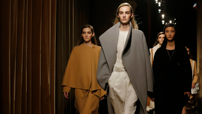 Models present creations by French designer Christophe Lemaire as part of his Fall/Winter 2014-2015 women's ready-to-wear collection for fashion house Hermes during Paris Fashion Week