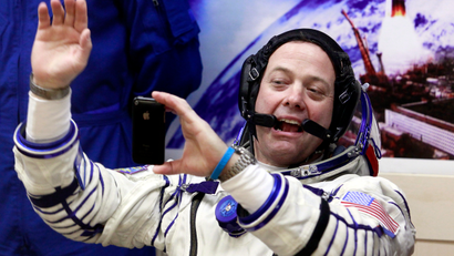 U.S. astronaut Ron Garan, crew member of the mission to the International Space Station, ISS, takes a photo of himself by mobile phone prior to the launch of Soyuz-FG rocket at the Russian leased Baikonur cosmodrome, Kazakhstan, Tuesday, April 5, 2011.