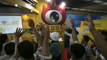 In this June 19, 2005 file photo, Chinese visitors to a property fairs compete to answer questions at a booth promoting the real estate web site of one of China's biggest Internet company, Sina Corps at a property fair in Beijing. China's two biggest microblog sites resumed normal service Tuesday, April 3, 2012 after a three-day ban on posting comments that sparked complaints about censorship amid the country's worst high-level political crisis in years. The temporary suspension by Sina's Weibo.com and Tencent's t.qq.com followed a flurry of rumors online about the downfall of a prominent Communist Party figure, Bo Xilai.