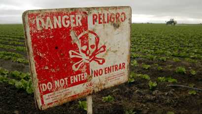 Pesticide-related sign warns people not to enter a farm field.