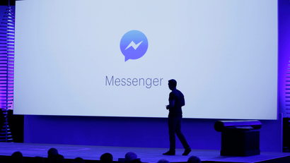 FILE - In this Tuesday, April 12, 2016 file photo, David Marcus, Facebook Vice President of Messaging Products, watches a display showing new features of Messenger during the keynote address at the F8 Facebook Developer Conference in San Francisco. On Friday, July 8, 2016, the company says it is testing an option for “secret conversations,” encrypted chats that can only be read by the people sending and receiving the messages, to its Messenger app. (AP Photo/Eric Risberg)