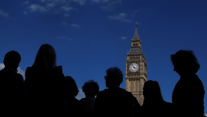 Tourists view the Elizabeth Tower, which houses the Great Clock and the 'Big Ben' bell, at the Houses of Parliament, in central London