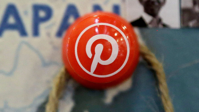 A pin with the Pinterest logo on the head is pinned into a map of Japan.