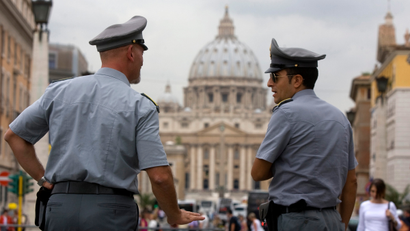 In this Tuesday, Sept. 21, 2010 file photo Italian financial Police officers talk to each other in front of St. Peter's square at the Vatican. A Rome court has upheld the seizure of €23 million (€31 million) from a Vatican bank account, and the Holy See is expressing "astonishment" over the decision. Vatican spokesman the Rev. Federico Lombardi says the Holy See "learned of the ruling with astonishment." Lombardi said Wednesday, oCT. 20, 2010 that Vatican bank officials maintain they can clarify the matter soon. The seizure last month was based on alleged violations of Italy's laws against money laundering. Lombardi indicated that the Vatican is contending the problem is a matter of how the regulations are interpreted.