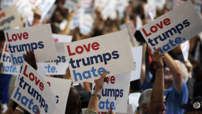 People hold anti-Donald Trump signs