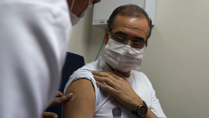 A nurse administers China's SinoVac coronavirus potential vaccine to a volunteer in Brazil