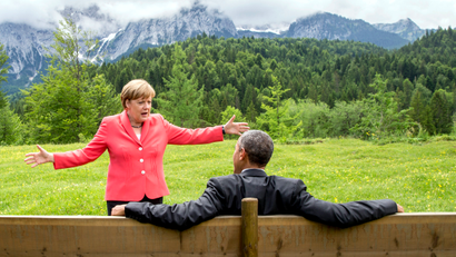 German Chancellor Angela Merkel speaks with U.S. President Barack Obama outside the Elmau castle in Kruen near Garmisch-Partenkirchen, Germany, June 8, 2015. Leaders of the Group of Seven (G7) industrial nations vowed at a summit in the Bavarian Alps on Sunday to keep sanctions against Russia in place until President Vladimir Putin and Moscow-backed separatists fully implement the terms of a peace deal for Ukraine.