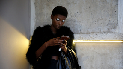 A model uses her mobile phone as she waits before the German designer Lutz Huelle Spring/Summer 2017 women's ready-to-wear collection during Fashion Week in Paris, France September 30, 2016. REUTERS/Gonzalo Fuentes
