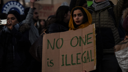 People participate in a protest against President Donald Trump's muslim ban.