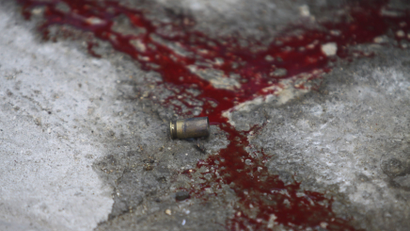 A bullet shell is seen near blood at a crime scene in Emiliano Zapata neighborhood in Acapulco