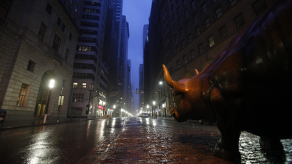Wall Street Bull sculpture on deserted Broadway in New York as Hurricane Irene closed in on New York City