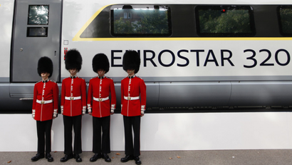 Four members of the Scot's Guards pose for a photograph next to a new Eurostar train.