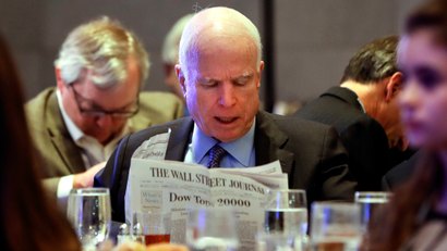 Sen. John McCain, R-Ariz. reads the Wall Street Journal newspaper as he waits for President Donald Trump to speak at the House and Senate GOP lawmakers at the annual policy retreat in Philadelphia, Thursday, Jan. 26, 2017.