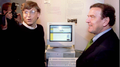 Microsoft mogul Bill Gates (L) shows Germany's Lower Saxony Prime Minister Gerhard Schroeder how to access the Internet during Schroeder's tour of the software company's Redmond, Washington campus, May 1.