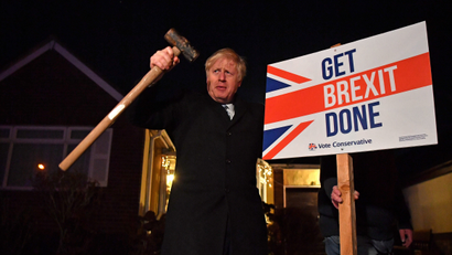 Britain's Prime Minister and Conservative party leader Boris Johnson poses with a sledgehammer, after hammering a "Get Brexit Done" sign into the garden of a supporter, in South Benfleet, Britain December 11, 2019.